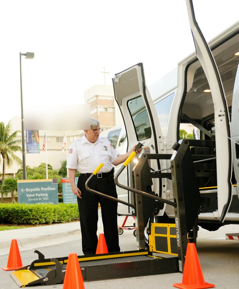 NEMT driver assisting passenger